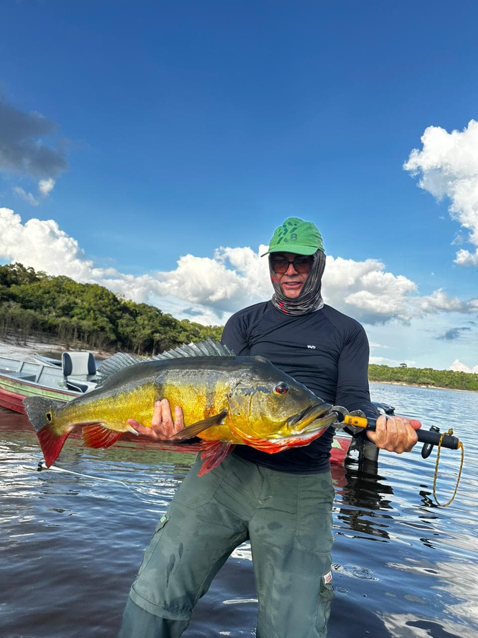 Hóspede exibe tucunaré durante pesca esportiva